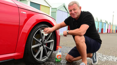 Auto Express special contributor Steve Sutcliffe cleaning the Audi TT&#039;s damaged wheel